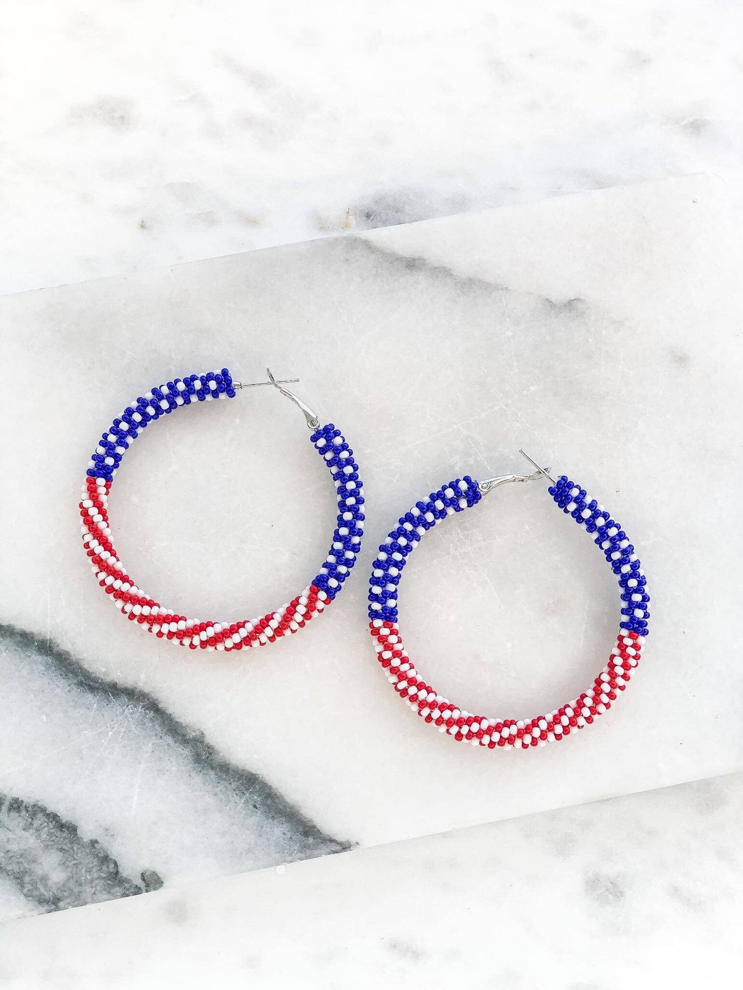 Beaded hoop earrings. Top half has blue and white beads, representing the stars portion of the flag. Bottom half has red and white beads, representing the stripes portion of the flag.