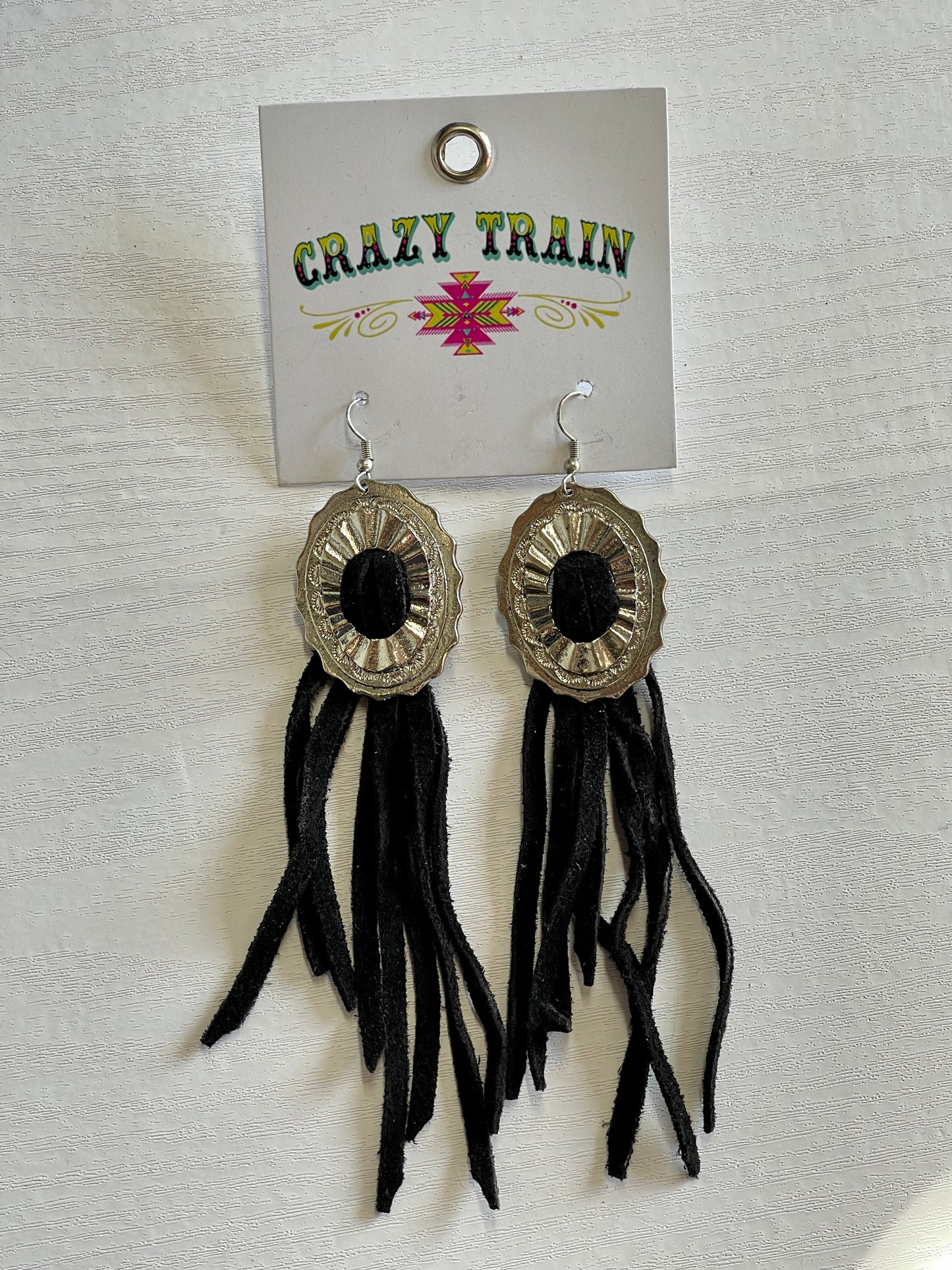 Crazy train earrings.  Black leather tassels pulled through silver metal concho.